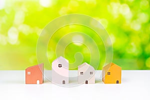 Different simulated housing and Real estate selection concept with green nature background and copy space
