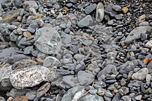 Different size stones on land of the river beach