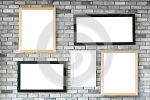 Different size and style empty photo frames on white concrete wa