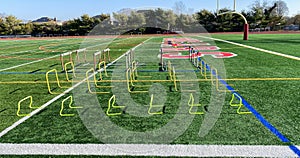 Different sized hurdles set up on turf field for stength and agility practice
