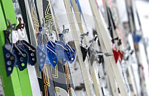 Different skis with bindings for ski boots are on the snow close-up