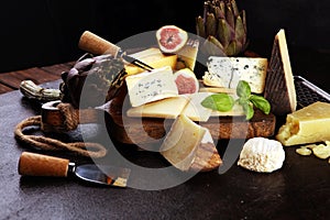 Different sorts of cheese. Cheese platter with different cheese and spice photo