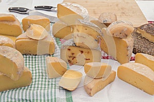 Different sorts of cheese wheels at a market photo