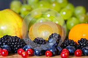 Different sorts of fresh raw fruits, making a fruit salad or smoothie