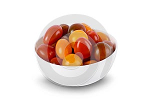 Different sorts of tomatoes served on a white bowl isolated on white background