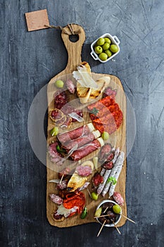 Different spanish embutidos on a table: jamon, chorizo, salami, cheese and wine. Top view