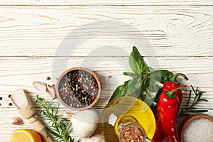 Different spices and herbs on wooden background, top view