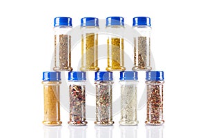 Different spices jars and pepper mill