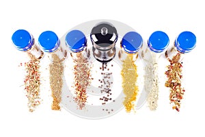 Different spices jars and pepper mill