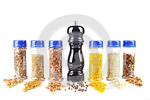 Different spices jars and pepper mill
