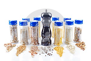 Different spices jars and pepper mill