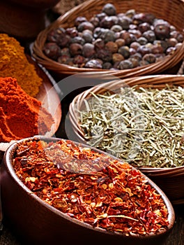 Different spices over a wood background.