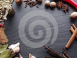 Different spices on rocked table.