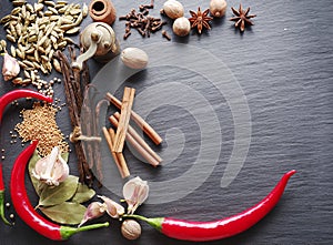 Different spices on rocked table.