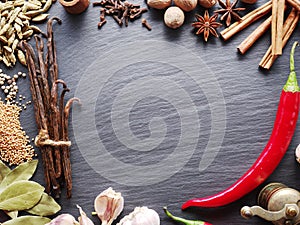 Different spices on rocked table.