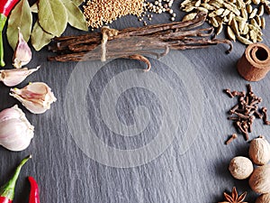 Different spices on rocked table.