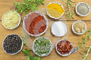Different spices in shiny bowls