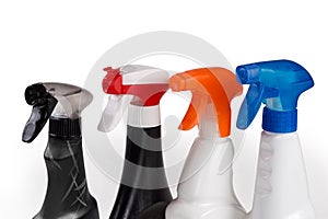 Different sprayers on plastic bottles of various household cleaning agent