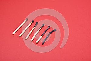 Different stages of match burning red background