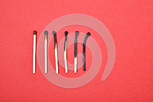 Different stages of match burning red background