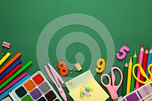 Different stationery on green background, flat lay with space for text. Back to school