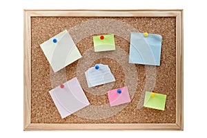 Different sticky notes on a cork board isolated