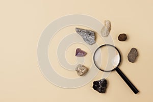 Different stones, precious and rocks on a beige background. Gemological concept. Study of minerals and bowels of the earth. photo