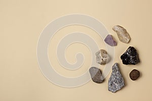 Different stones, precious and rocks on a beige background. Gemological concept. Study of minerals and bowels of the earth. photo