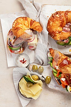 Different stuffed croissant. Croissant sandwich variety