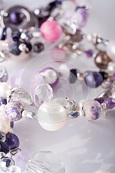 Different stylish jewelry bracelets with semiprecious  around  white background. hobby and fashion concept. macro shot photo