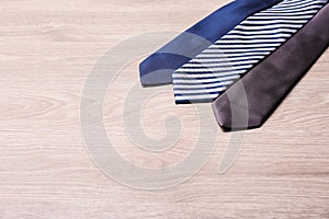 Different stylish neckties on wooden table