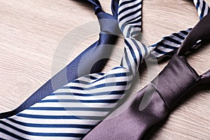 Different stylish neckties on wooden table