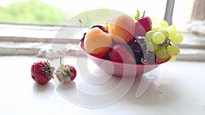 Different Summer fruits on a window sill