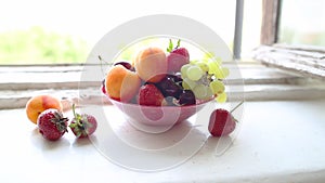 Different Summer fruits on a window sill