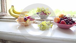 Different Summer fruits on a window sill