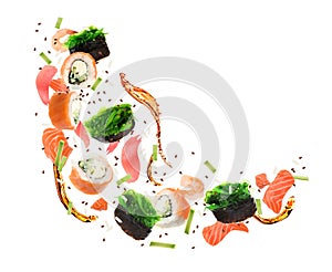 Different sushi rolls and ingredients on white background