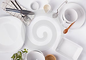 Different tableware and dishes on the white background, top view.