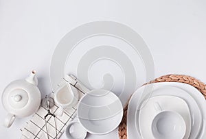 Different tableware and dishes on the white background, top view. photo