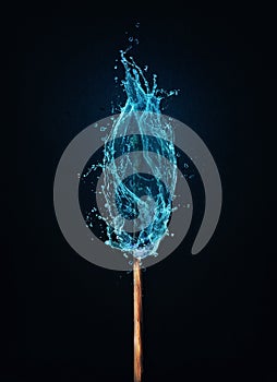 Different thinking concept as an unusual matchstick burning in a water flame. Blue liquid splash drops on a match, instead of fire