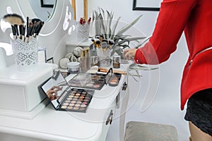 A Different tools and brushes for a make-up artist are on a table