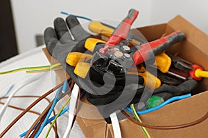 Different tools and cables in paper indoors. Installation of electrical wiring