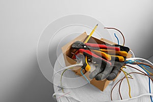 Different tools and cables in paper indoors. Installation of electrical wiring