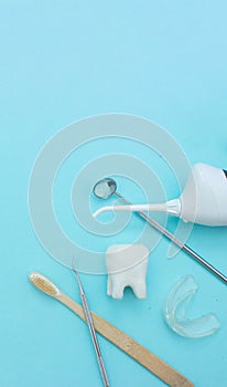 Different tools for dental care, toothbrush, dentist mirror, irrigator, removable braces, tooth mold and white tooth molar model