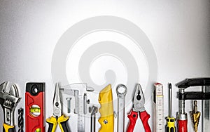 Different tools, instruments and accessories on grey metal background