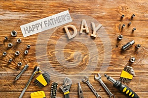 Different tools and text Happy Father's Day on wooden background