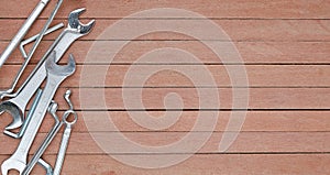 Different tools on a wooden plank background with copy space