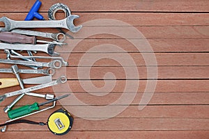 Different tools on a wooden plank background with copy space