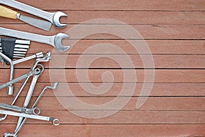 Different tools on a wooden plank background with copy space