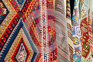 traditional turkish carpets hanging on a wall on a street in old town Kaleichi, Antalya, Turkey photo