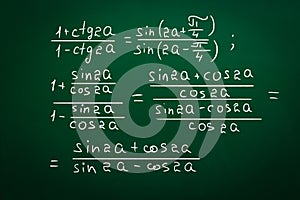 Different trigonometric identities written on green chalkboard photo